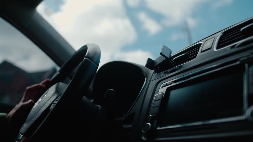 Person's hand turns a steering wheel