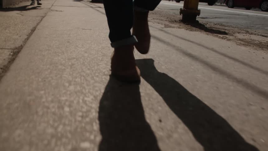 People are walking slowly on the sidewalk