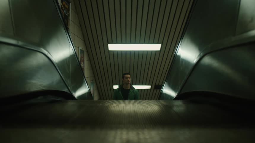 A man rides an escalator