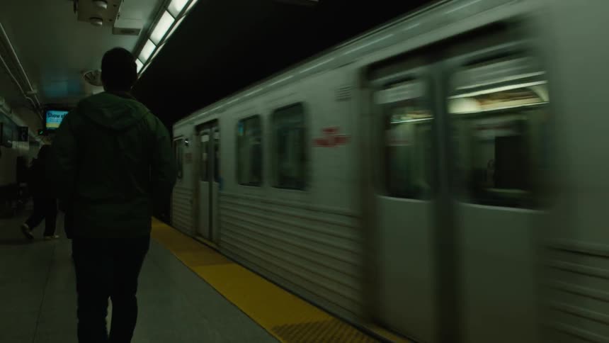 Commuters walk on a subway platform