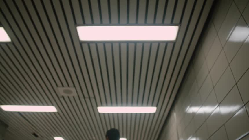 A man gets off the up escalator