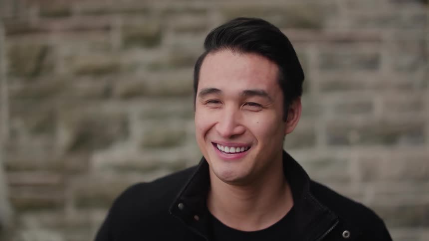 A man in black laughs
