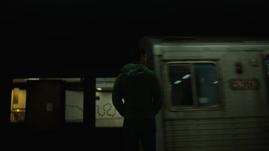 A man watches a train go by