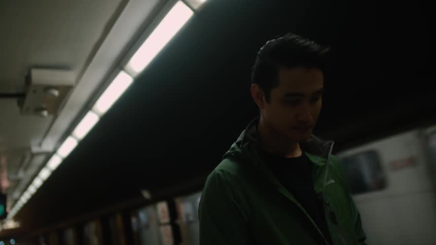 A man stands on a subway platform