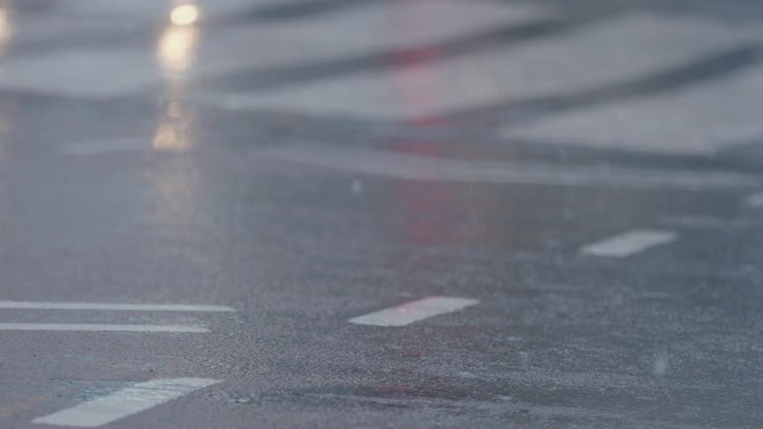 The snow slowly lands on the street