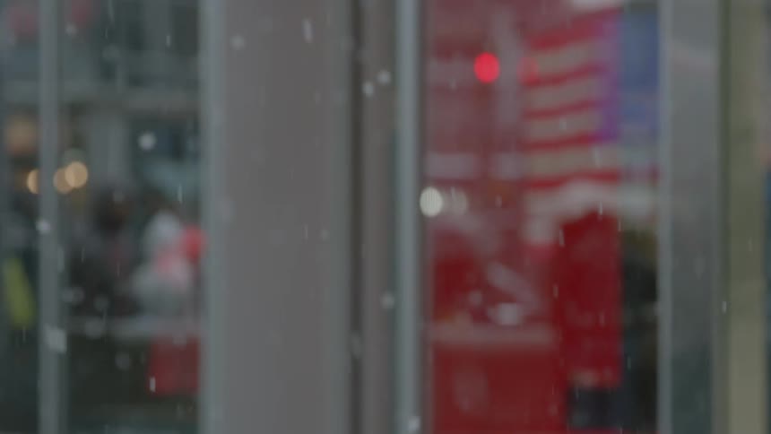 People wearing gloves and coats walk in the snow