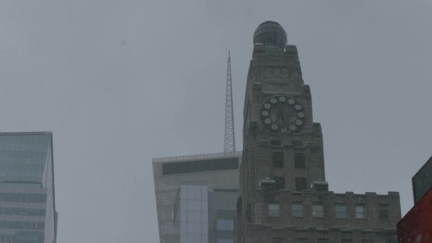 A large tower has a clock on the side
