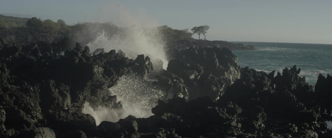 Waves crash against rocky cliffs