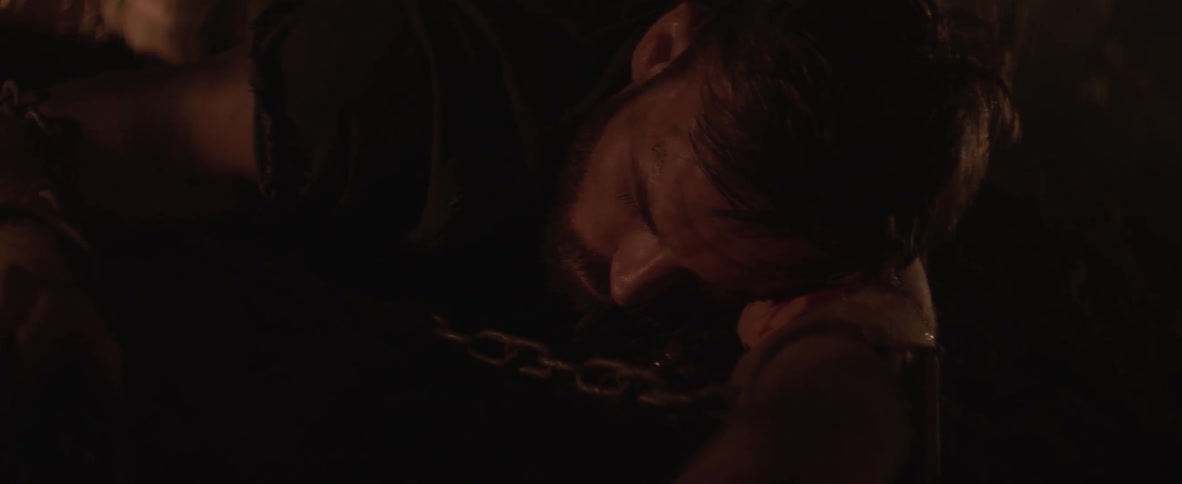 A man is sleeping on the ground