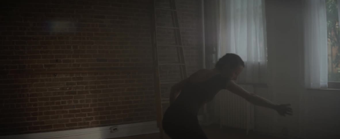 A dancer practices in an empty room