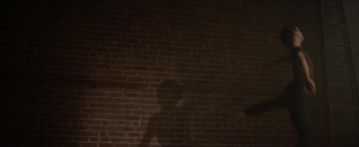 A ballerina leaps in a dance studio