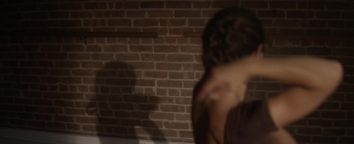 A ballerina dances in a studio