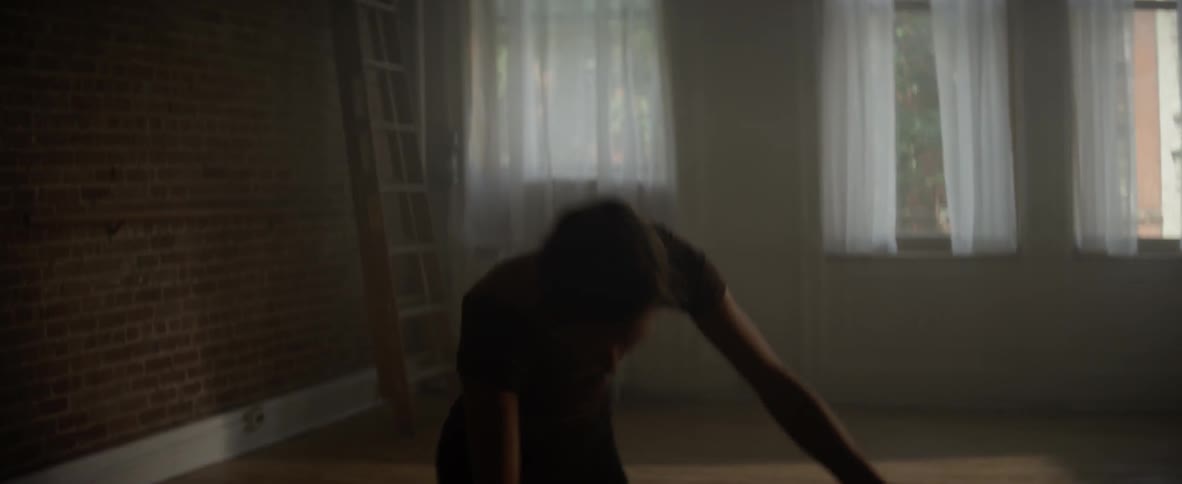 A ballerina dances in a studio