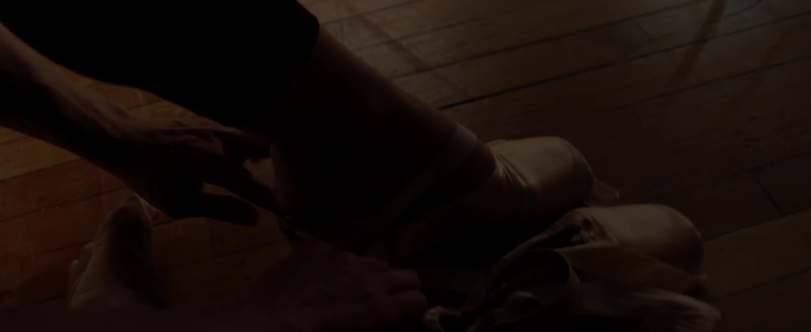 Ballerina puts on a pair of ballerina shoes