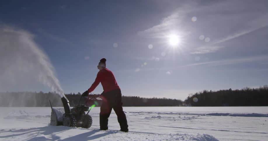A person using a snow blower