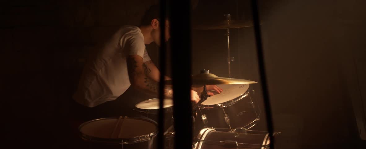 A man sits at a drumset