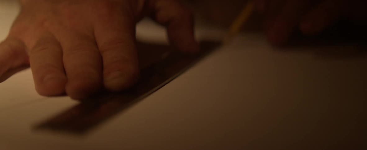 A man traces a pencil on paper