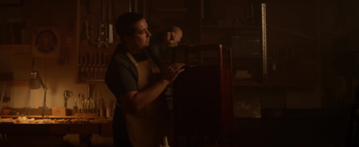 A man is working in a dark shop