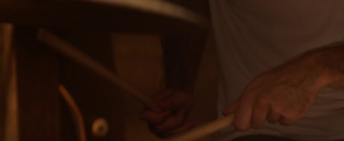 Drumsticks hitting a snare drum and cymbal