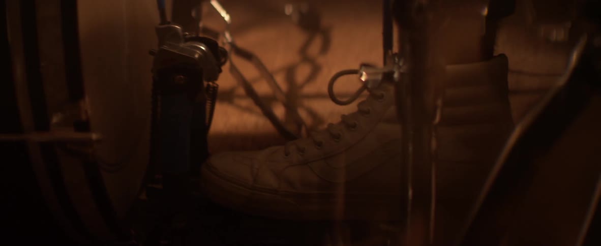 A drummer's foot pushes a drum pedal
