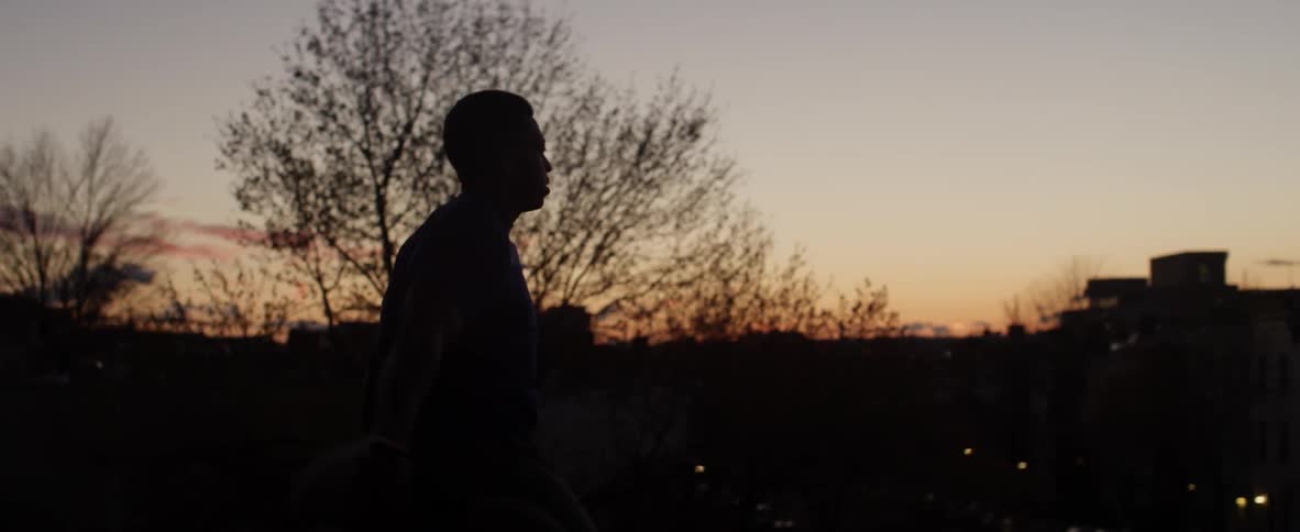 A man is stretching outside at dawn