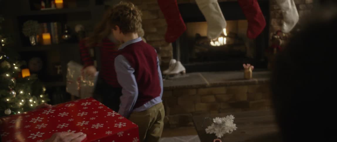 Children smile as they hand out gifts
