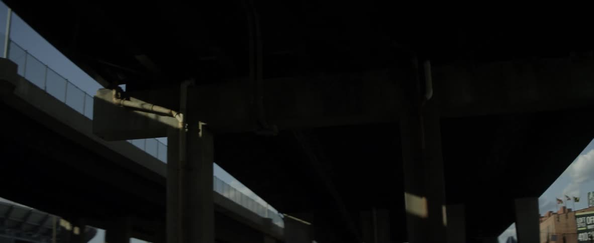 The underneath of a bridge in a city