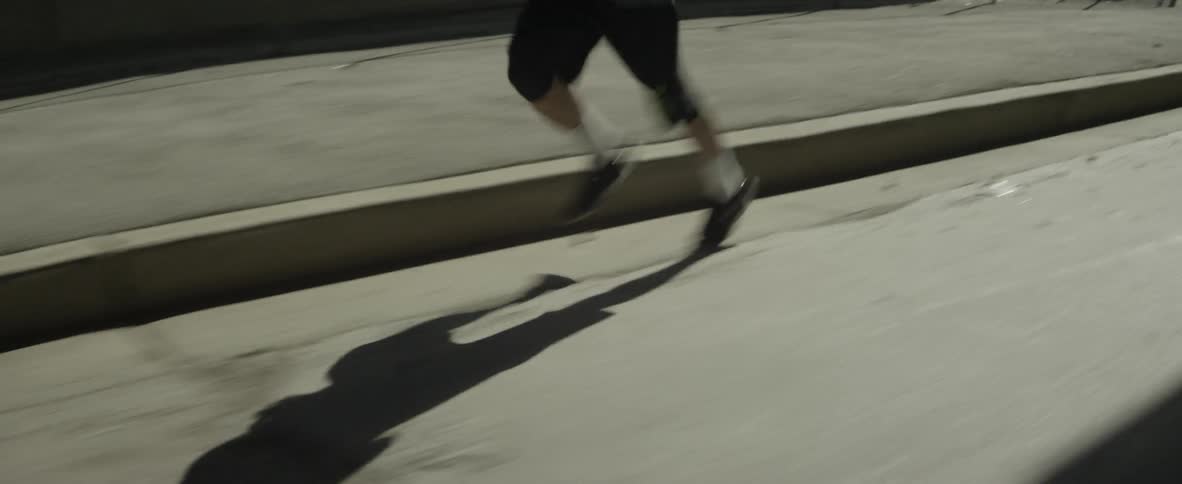 Man jogs in an industrial part of a city