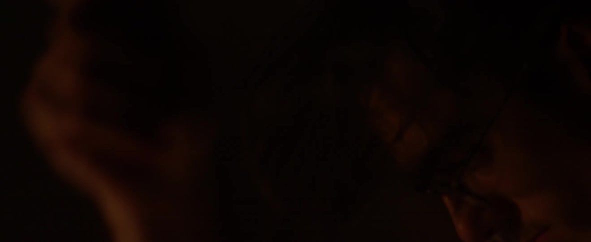 A man with dark hair plays the drums