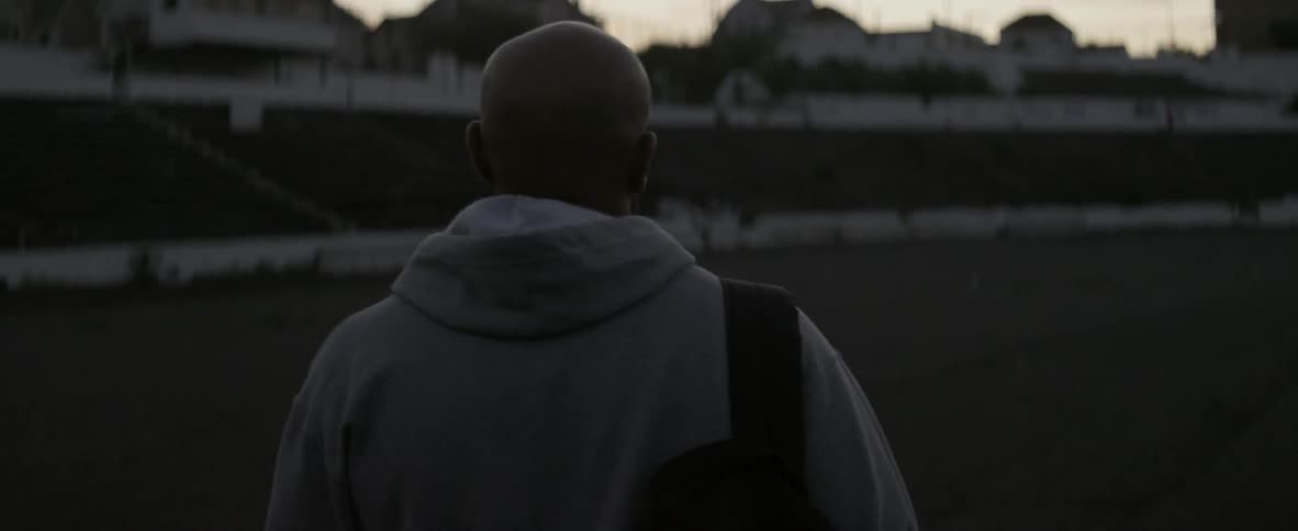Man walks outside in the city at sunset