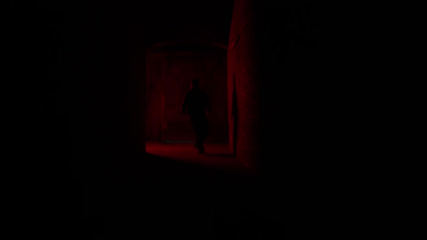 People run through a hallway that's lit red