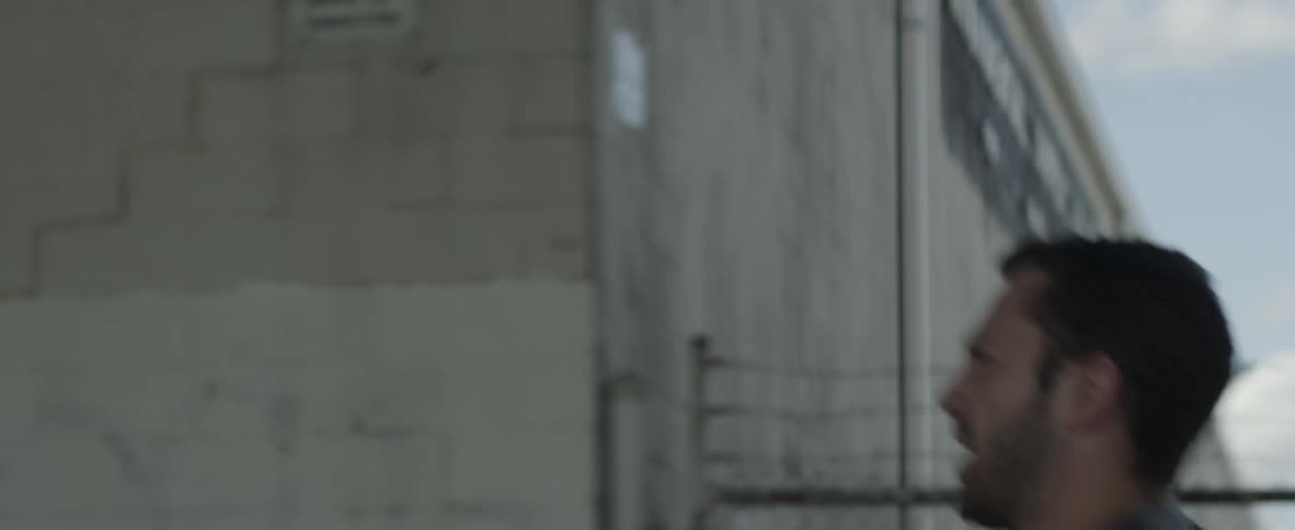 A man runs past a building
