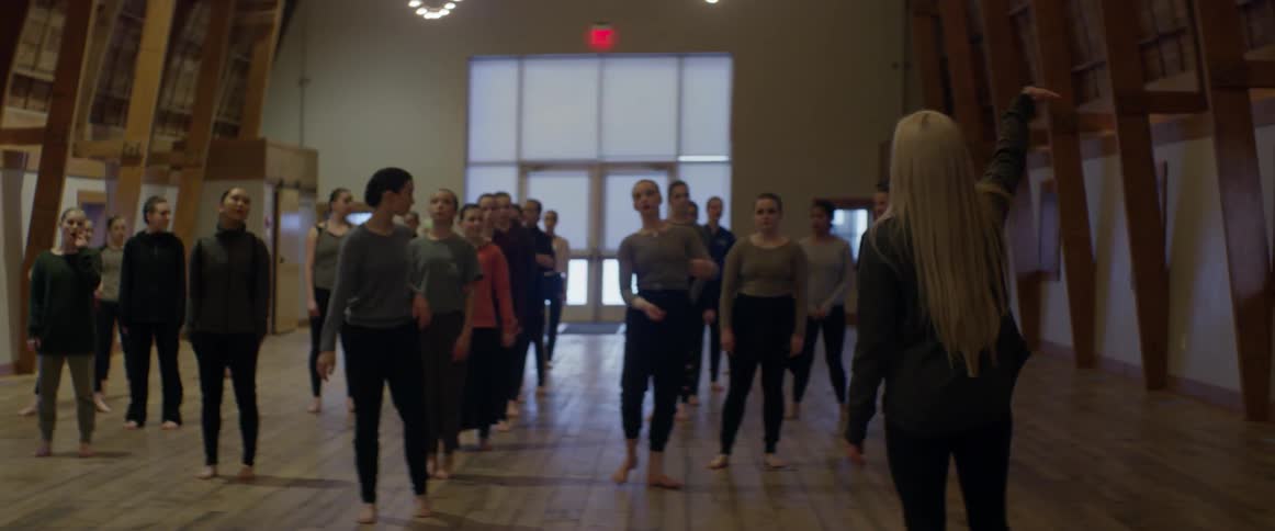A dance team rehearses in a studio