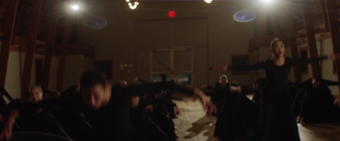 A dance team rehearses in a studio