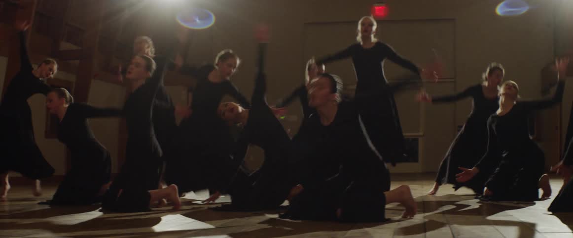 A dance team rehearses in a studio