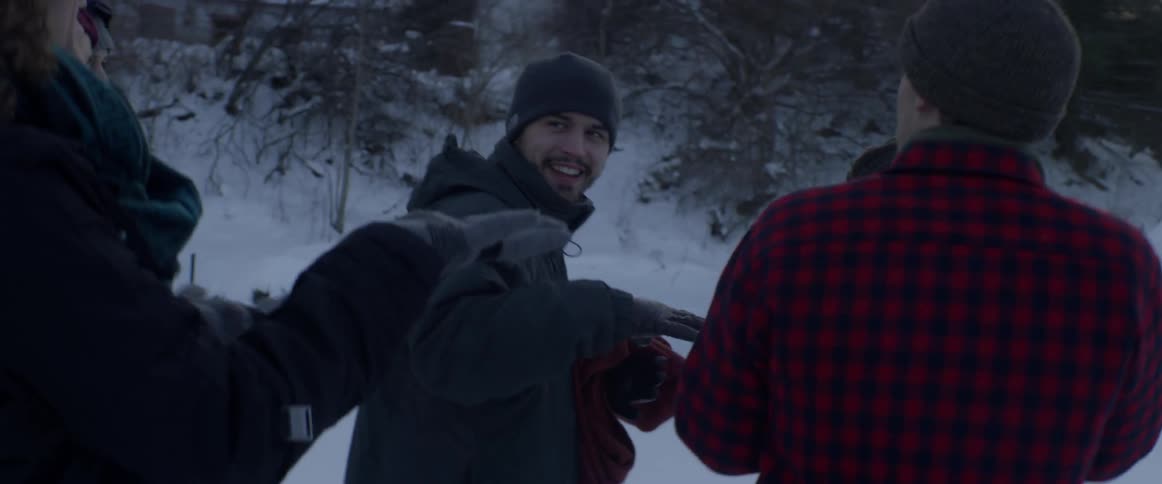 A group of friends walk outside on a snowy day