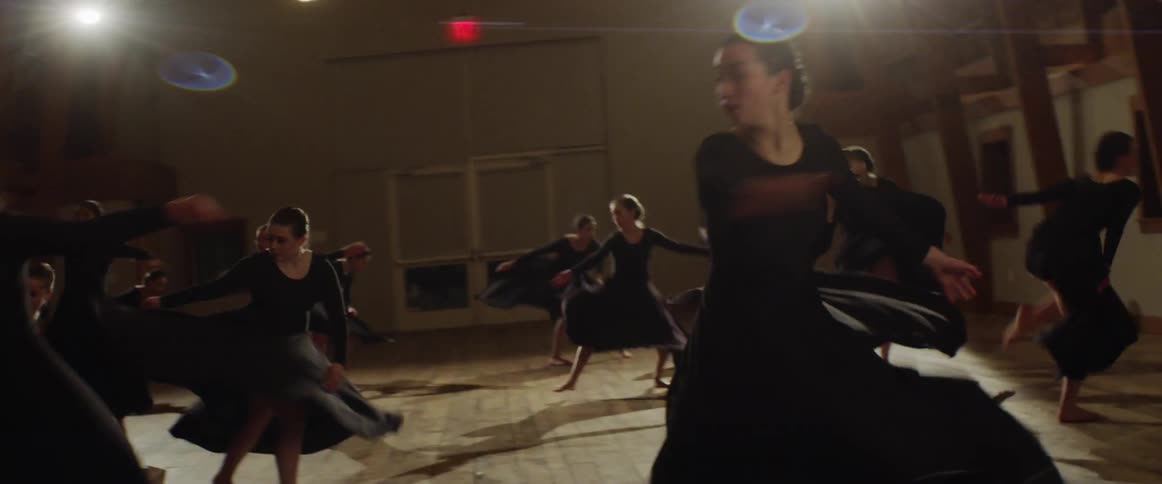 A dance team rehearses in a studio