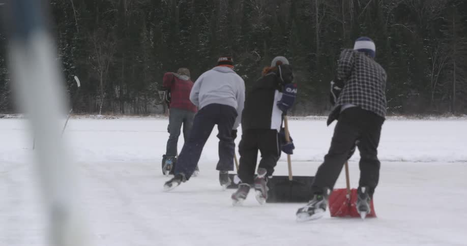 Men clean up ice to play ice hockey