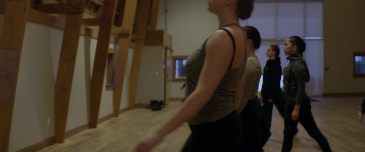Women dance together waving their arms