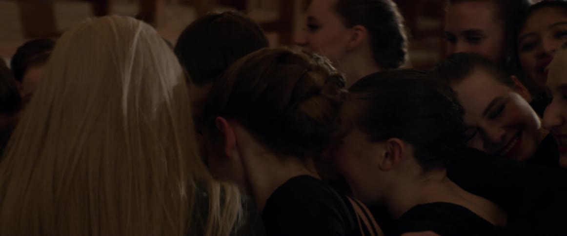 Large group of women smile and give each other hugs