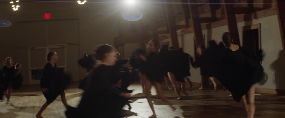 A dance team rehearses in a studio