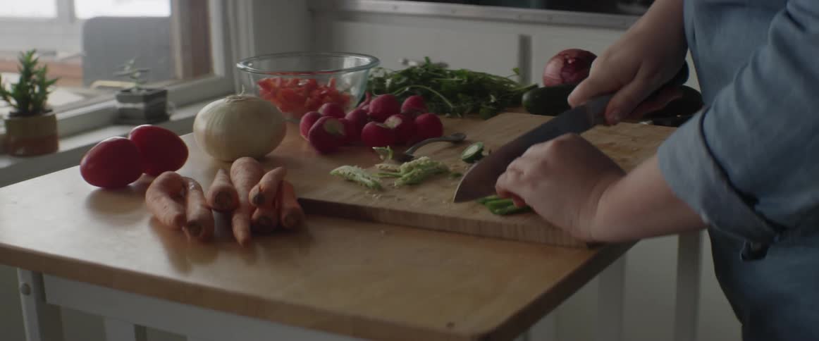 A person is preparing food in a kitchen