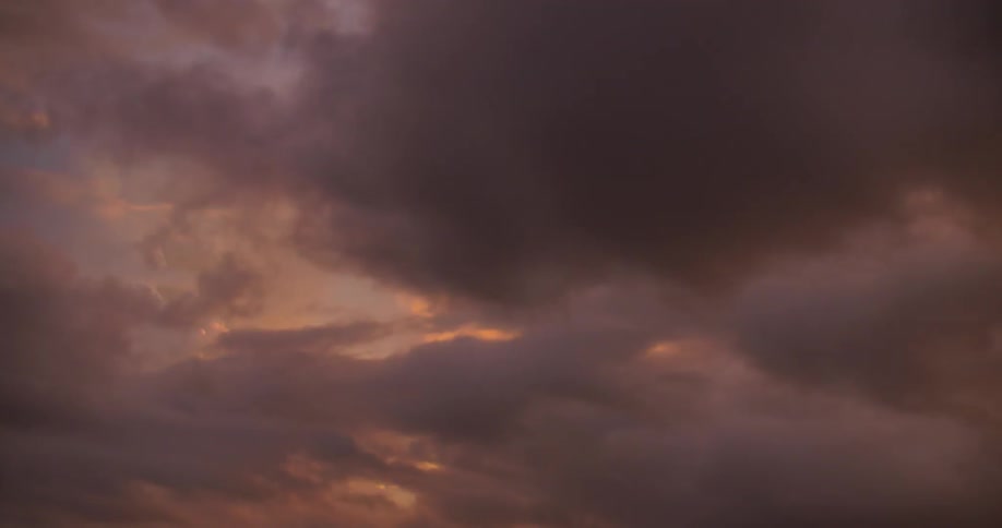 Clouds move along the sky at dawn