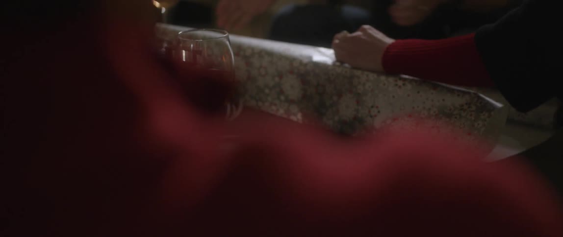 People at a table wrapping presents