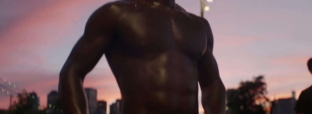 Sweaty shirtless man hops up and down at sunset