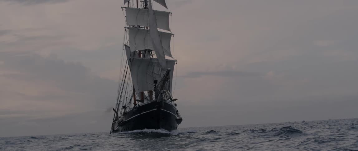 Ship sails in the ocean at sunset