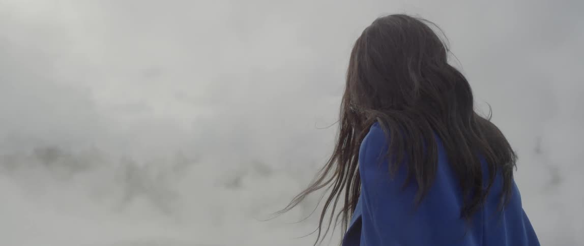 Woman stands outside in the fog