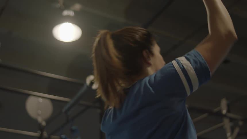 A woman pushes a weight above her head