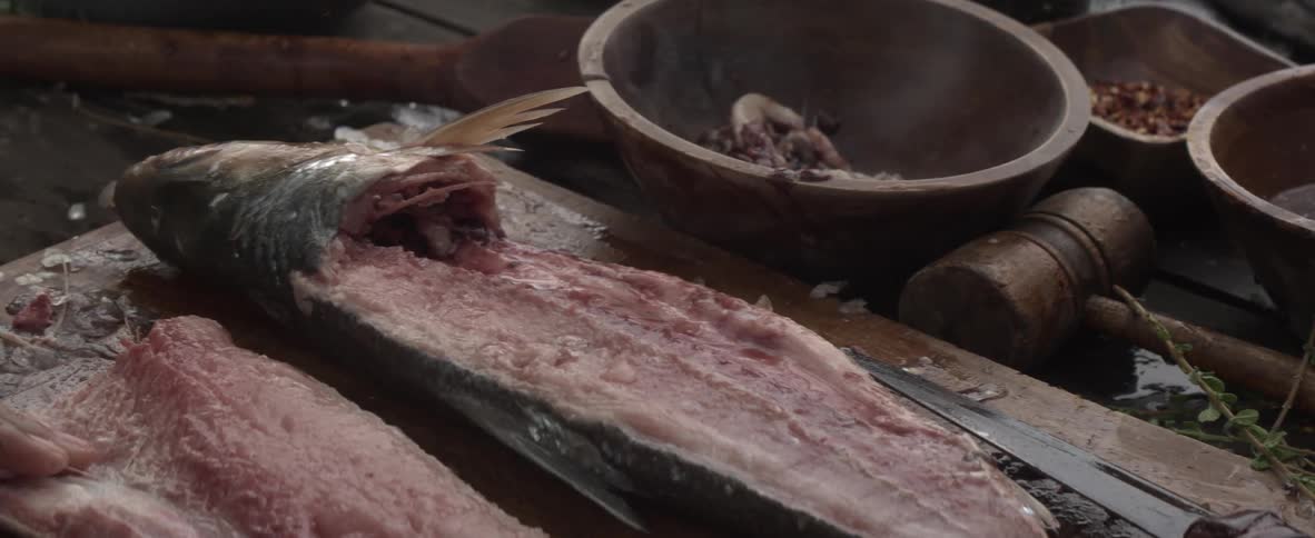 A chef fillets a fish