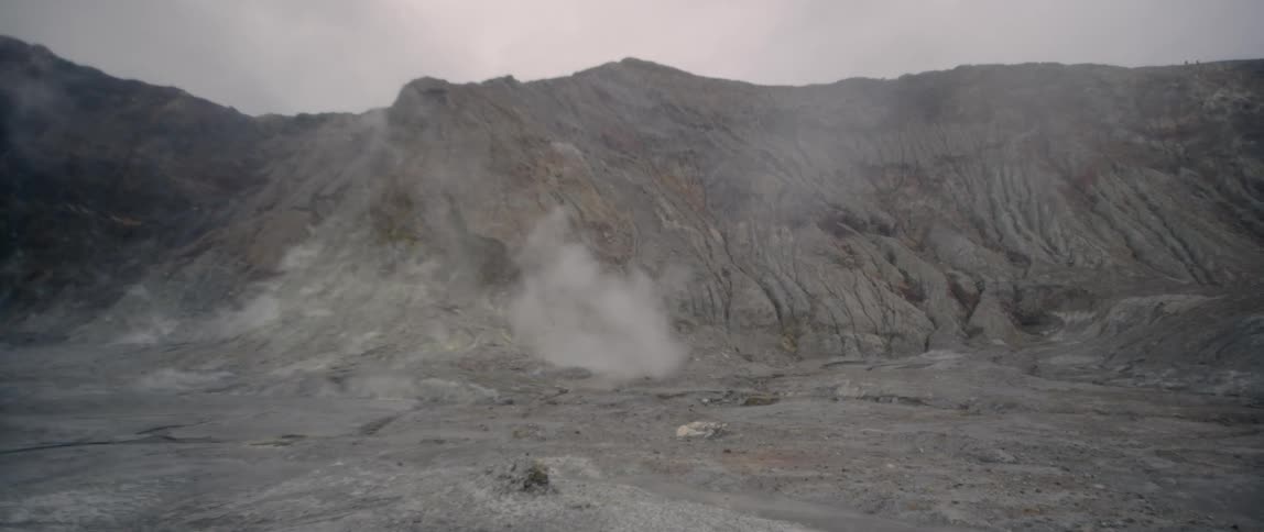 Smoke slowly rises from the mountain ahead